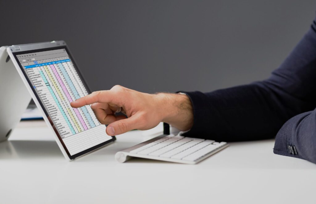 ERP eCommerce - Person Looking at Numbers on Tablet